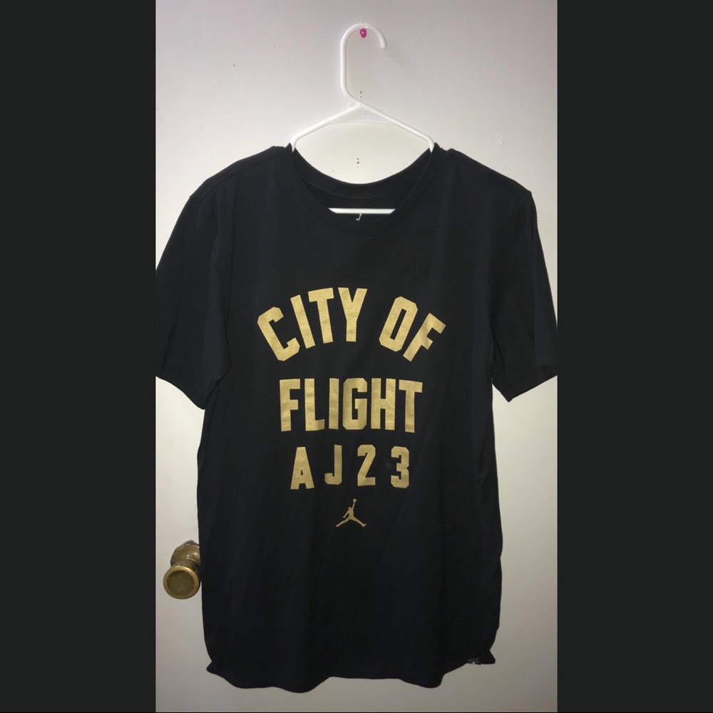A black shirt. Jordan. With gold letters.